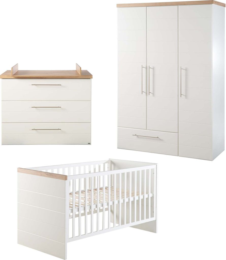 A nursery set including a crib, a dresser with a changing top, and a wardrobe, all in white with wood accents.