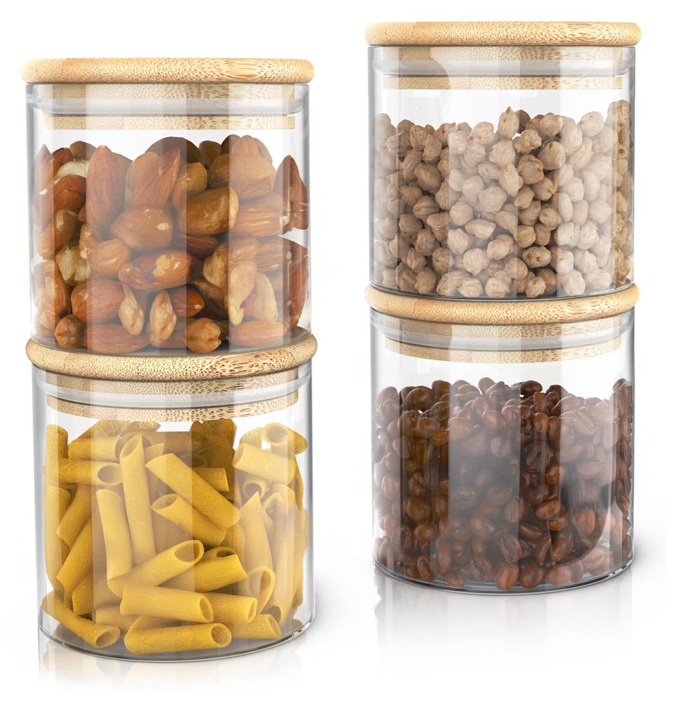 Four glass storage jars with bamboo lids are stacked in two columns of two.