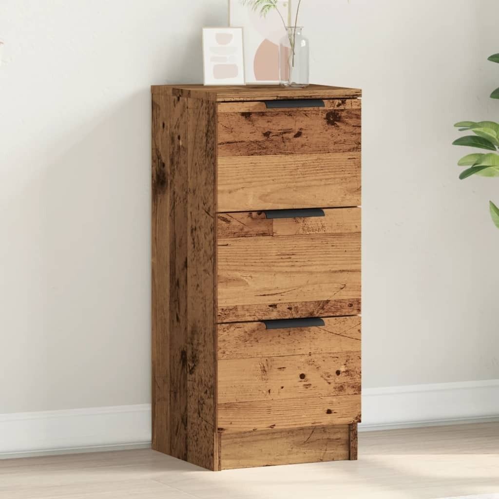 A wooden cabinet with three drawers is shown against a white wall.
