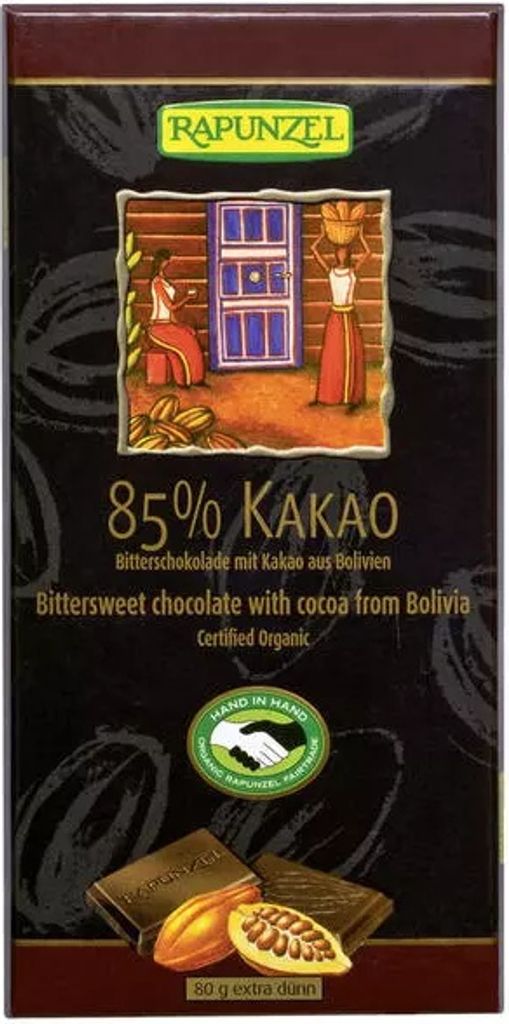 A chocolate bar wrapper with a colorful illustration of people and a doorway, along with images of cocoa beans and chocolate pieces.