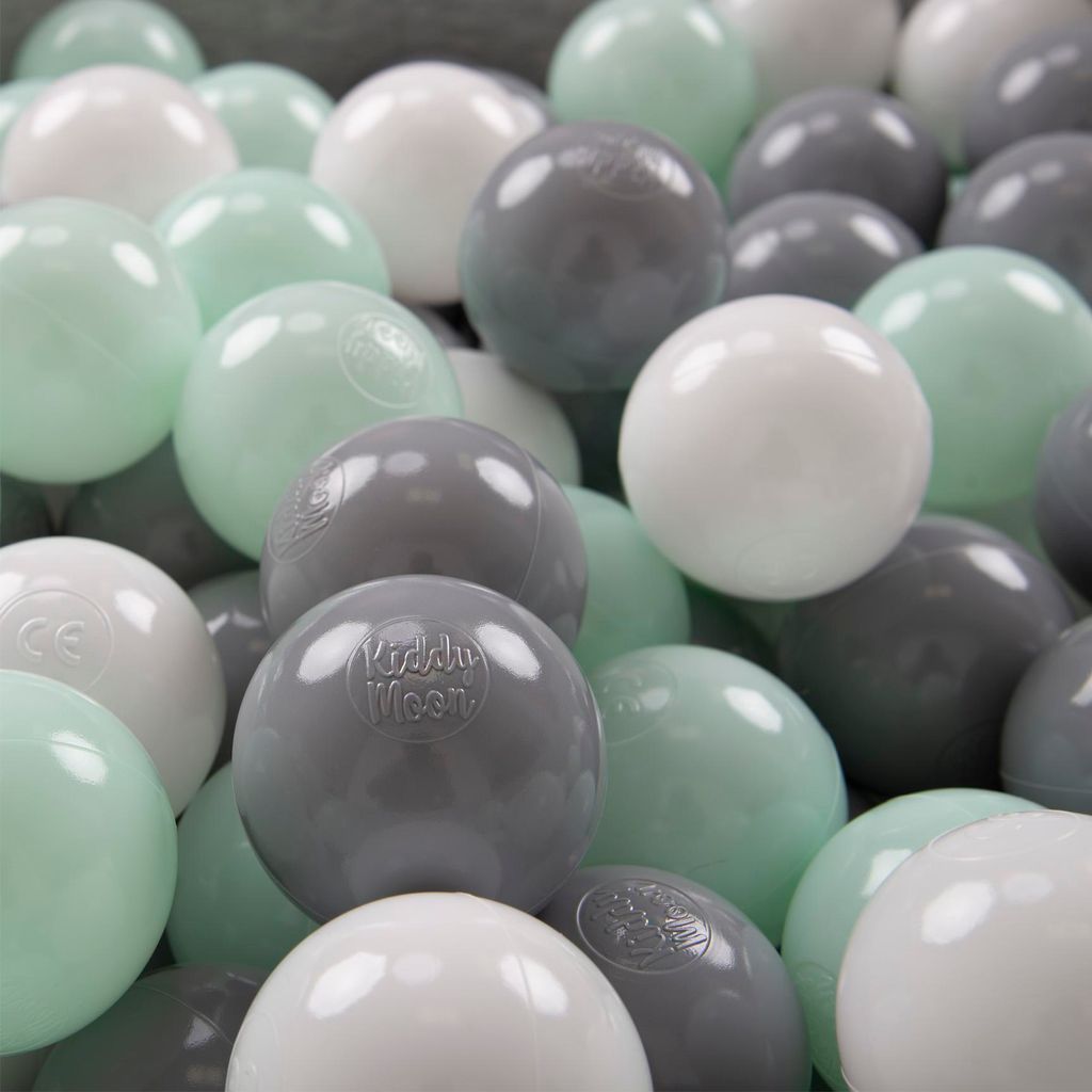 A close-up view of many colorful balls in a ball pit.