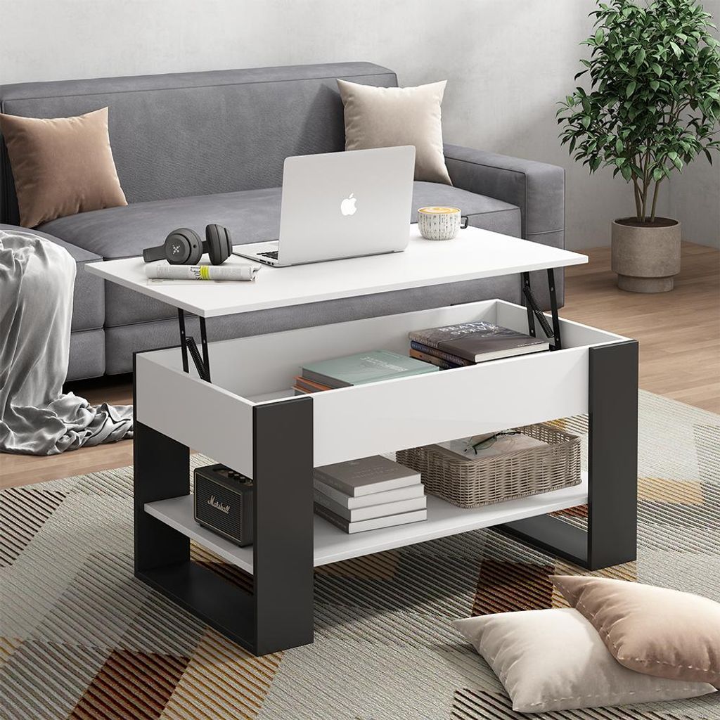 A modern living room scene with a lift-top coffee table in the center, a sofa in the background, and decorative pillows on the floor.
