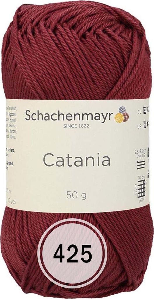 A ball of burgundy yarn with a label.
