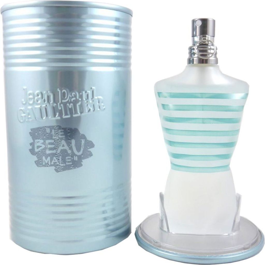 A bottle of Jean Paul Gaultier Le Beau Male Eau de Toilette and its cylindrical tin packaging are displayed against a white background.