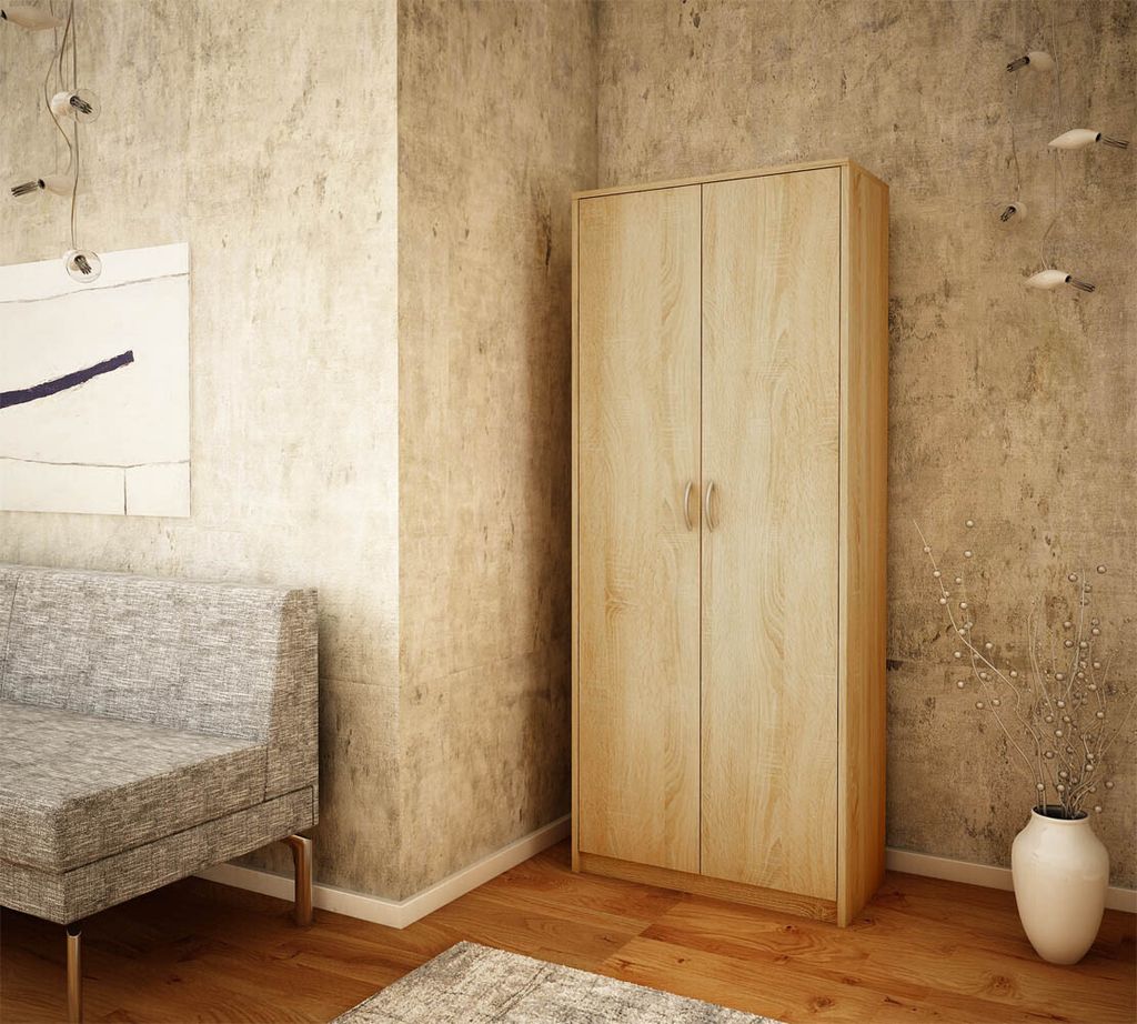 A bedroom corner with a wardrobe, sofa, and artwork.