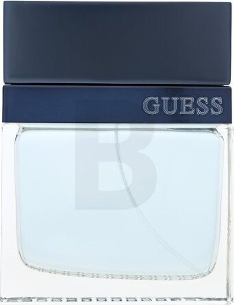 A close-up shot of a Guess Seductive Homme Blue eau de Toilette bottle.