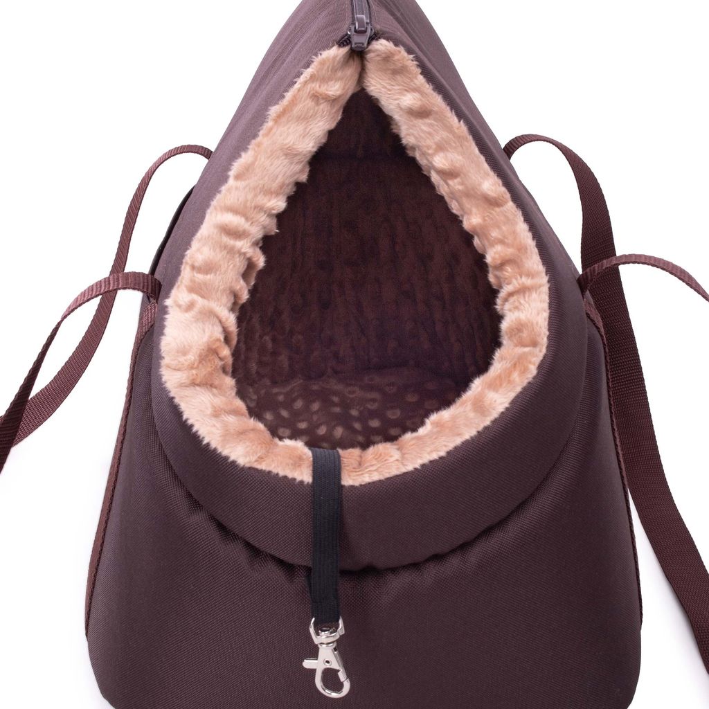 A close-up view of the opening of a brown pet carrier bag with a tan, fuzzy lining.