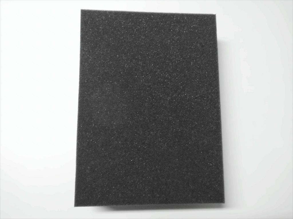 A single piece of black foam padding is shown against a white background.