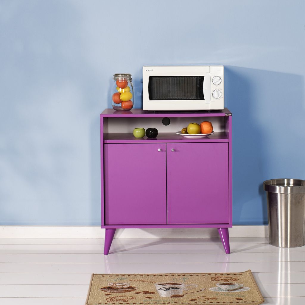 A purple cabinet with a microwave and fruit on top, set against a blue wall.