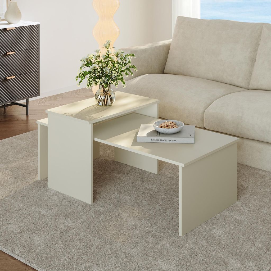A living room scene with a sofa, a side cabinet, and nesting coffee tables.