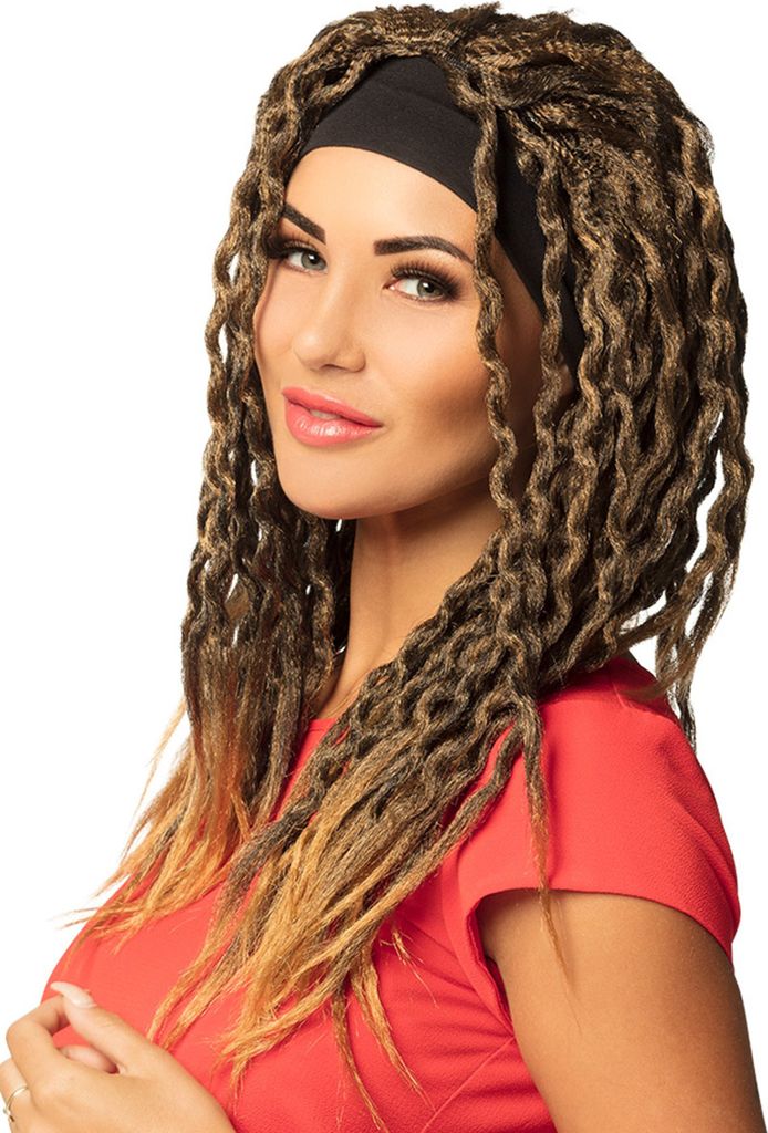A woman wearing a red shirt and a black headband, with long, braided dreadlock-style hair extensions.