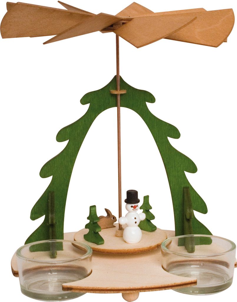 A wooden Christmas pyramid with a snowman, trees, and a rabbit.