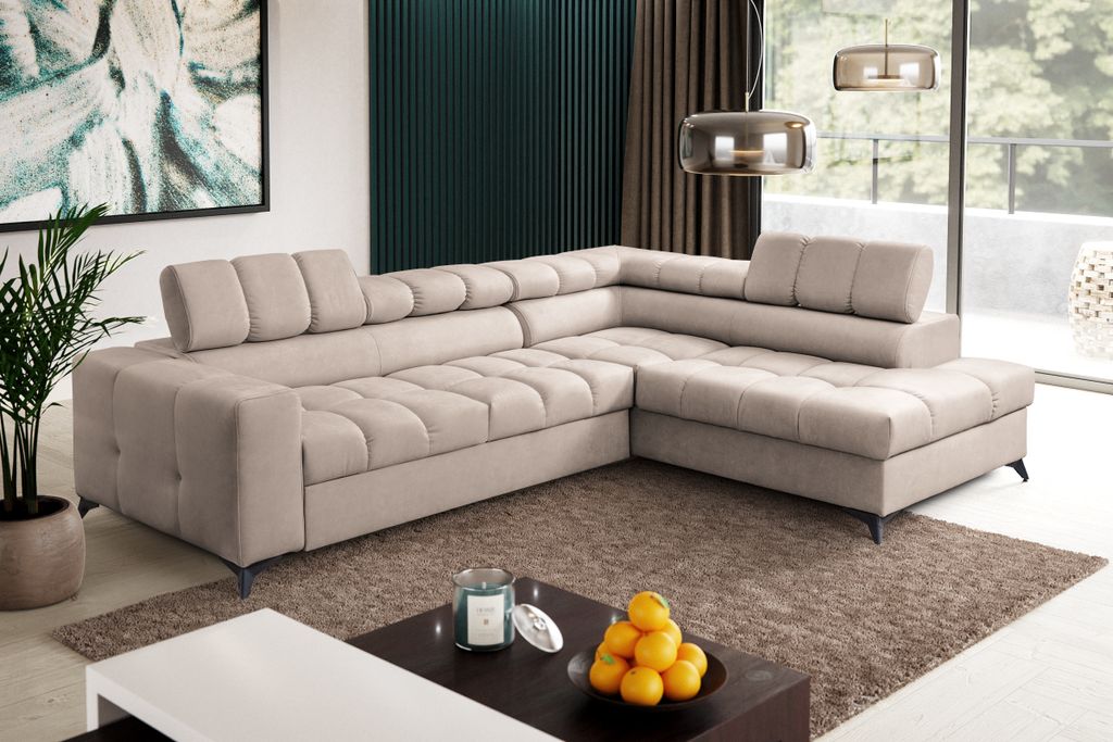 A modern living room with a large sectional sofa, coffee table, and artwork.