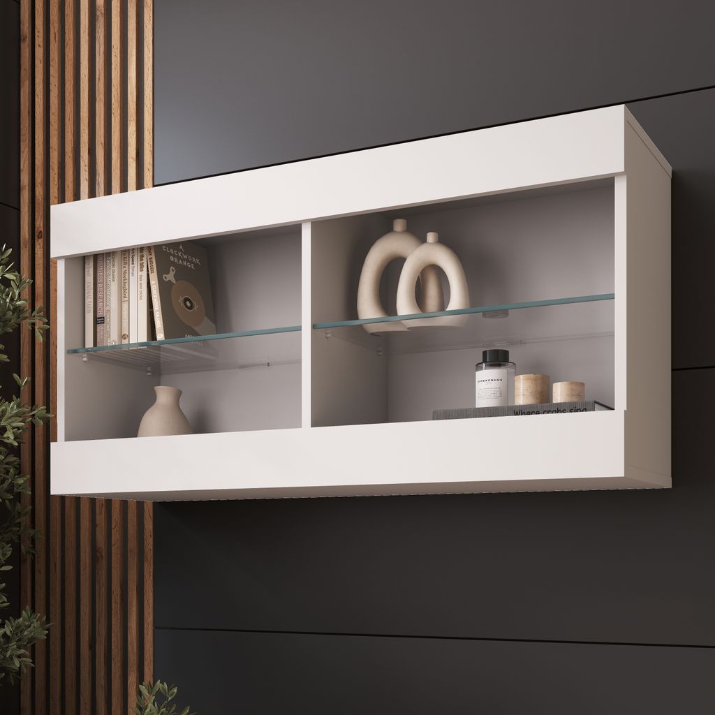 A white wall-mounted cabinet with glass shelves, displaying decorative items and books.
