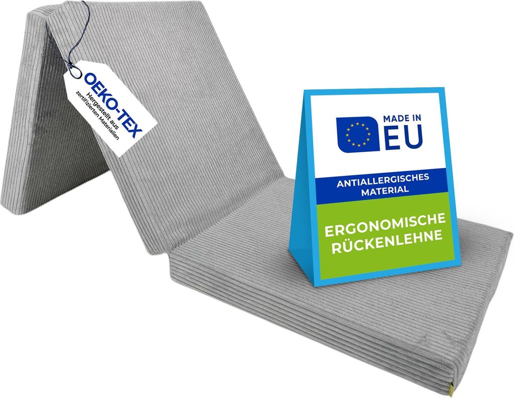 A folded gray mattress with labels indicating certifications and origin.