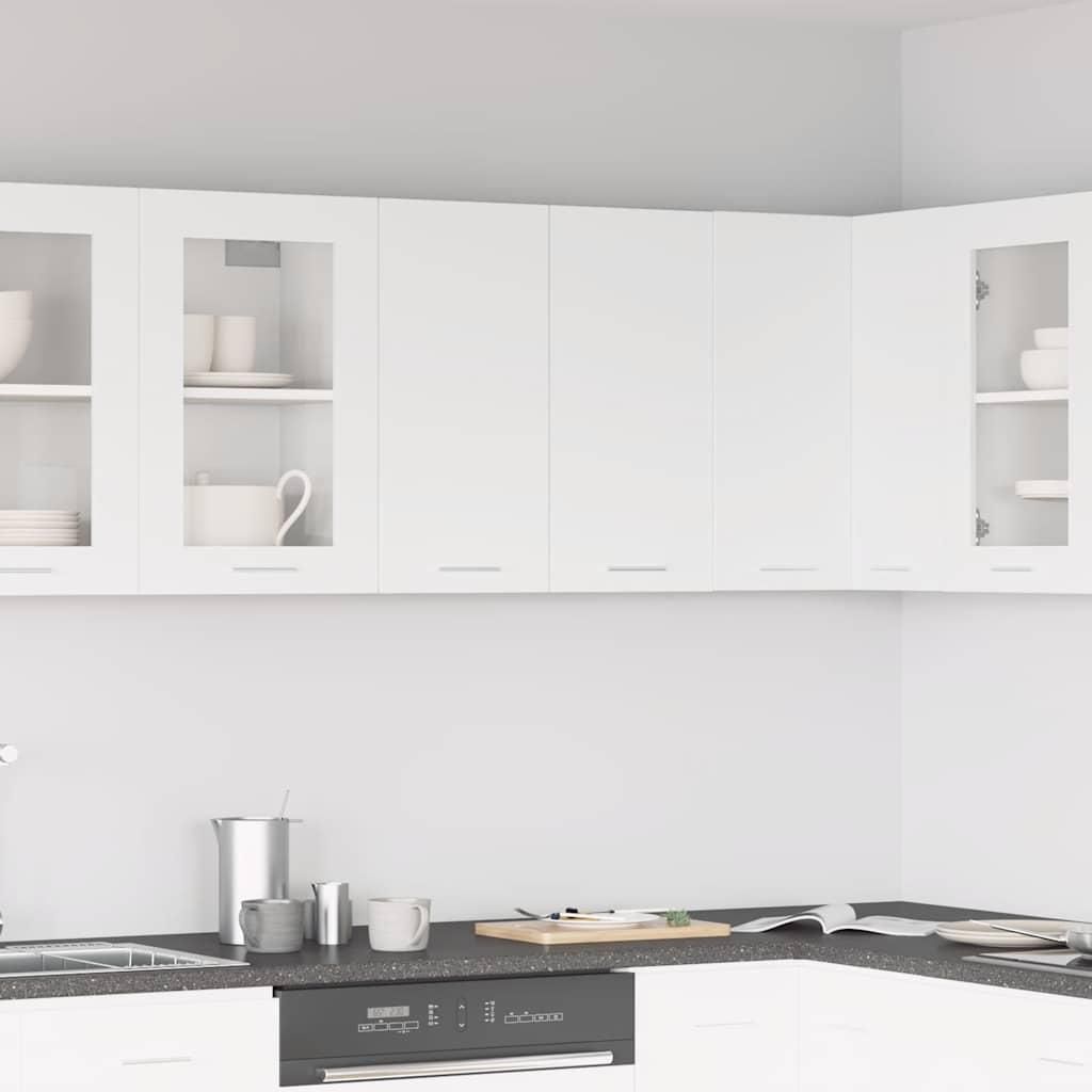 A clean, modern kitchen with white upper cabinets.