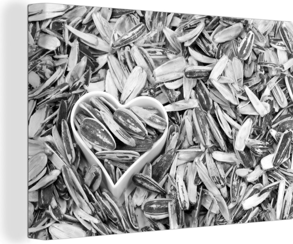 OneMillionCanvasses - Leinwandbilder - 140x90 cm, Sonnenblumenkerne mit einem herzförmigen Aussehen zwischen den Kernen - schwarz und weiß, Wan...