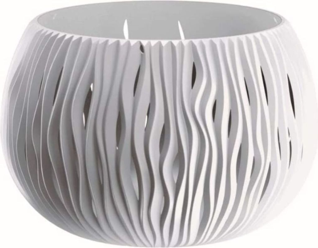A white, decorative planter bowl with a wavy, cut-out design.