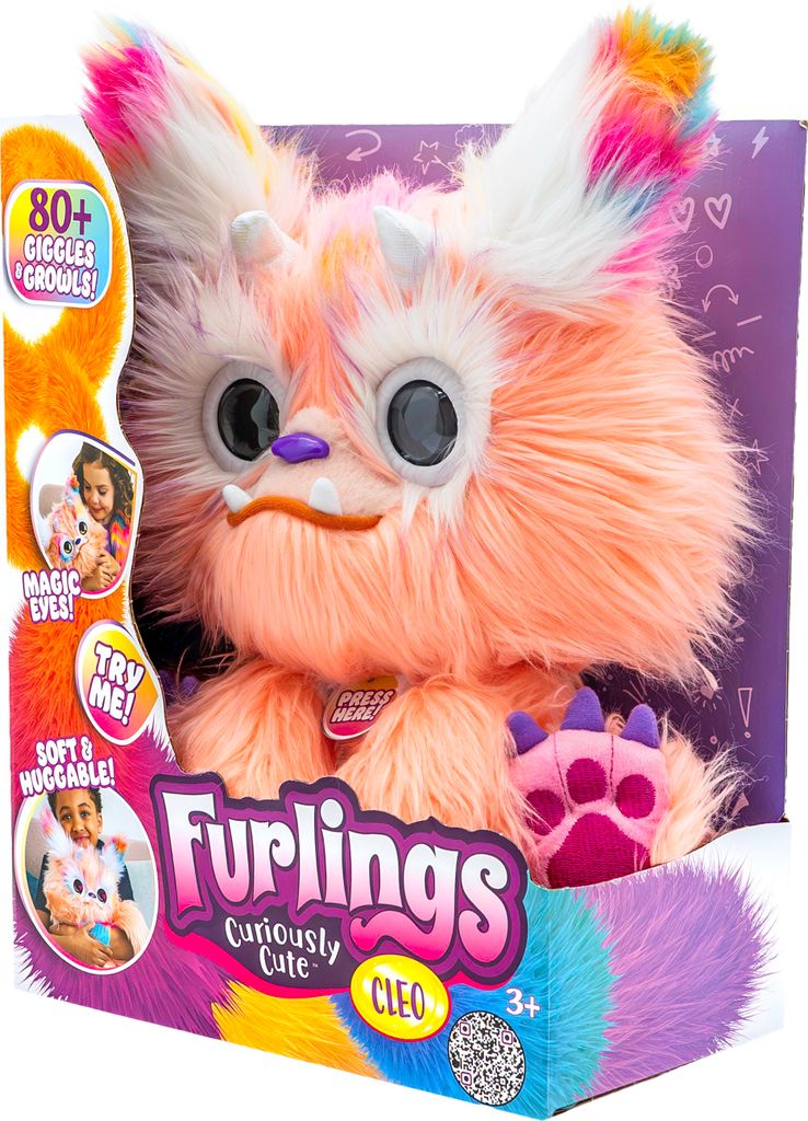 A toy creature named Cleo from Furlings is shown in its packaging. The packaging has colorful graphics and text describing the toy's features.