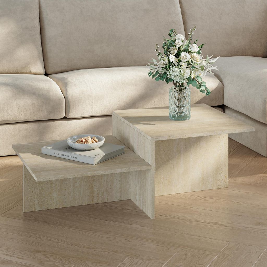 A modern living room setting with a couch and a two-tiered coffee table.