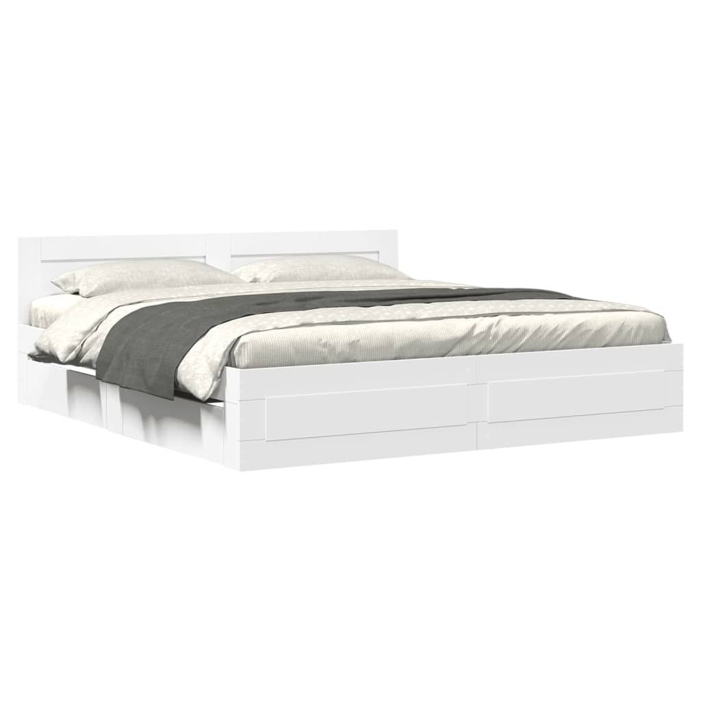 A white bed frame with a headboard and drawers, shown from a side angle with bedding.