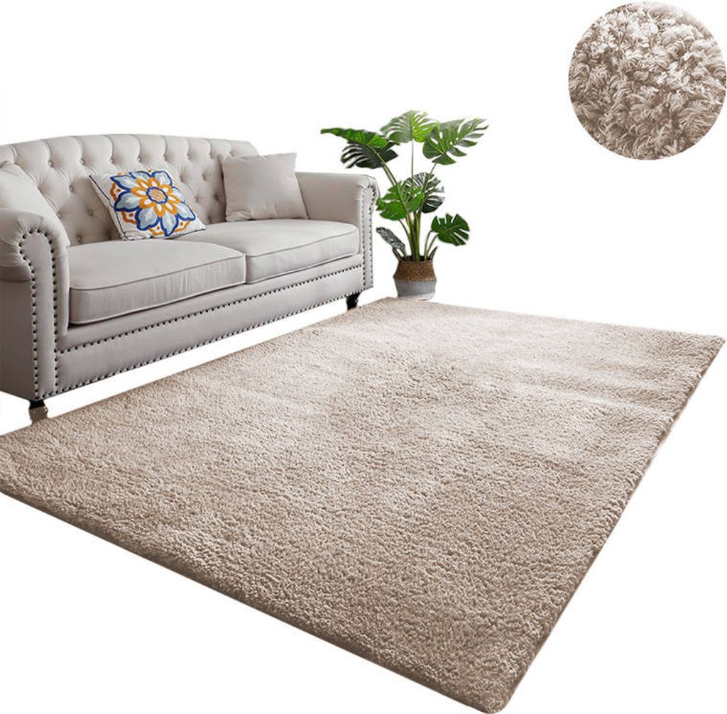 A beige rug is shown in front of a light-colored sofa with a potted plant to the side. A close-up of the rug texture is shown in a circular inset.