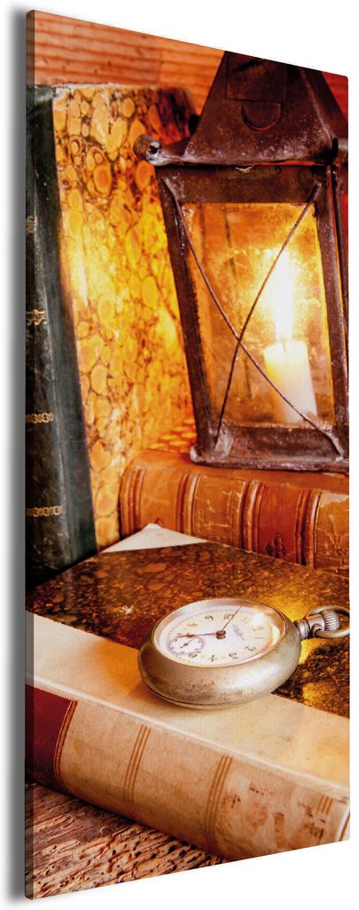 Wallario Premium Leinwandbild Antike Laterne mit Kerze alten Büchern und Taschenuhr in Größe 50 x 125 cm