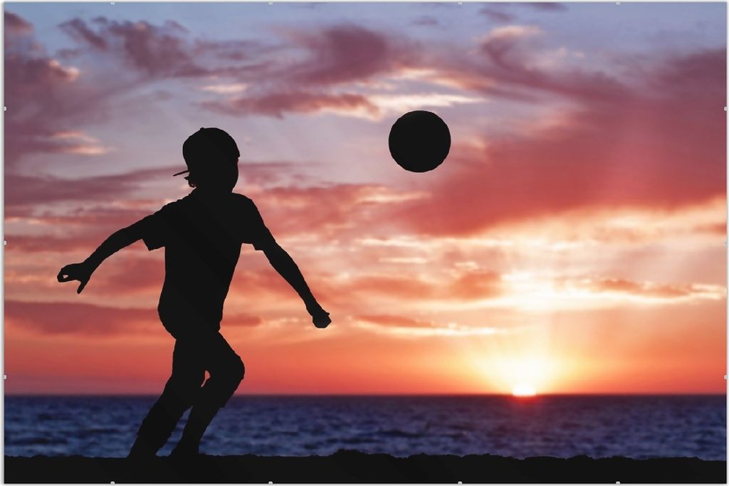 Wallario Wandbild Fußball - Kleiner Junge spielt im Abendrot, Größe: 61 x 91,5 cm, Poster mit rahmenlosen Bildhalter