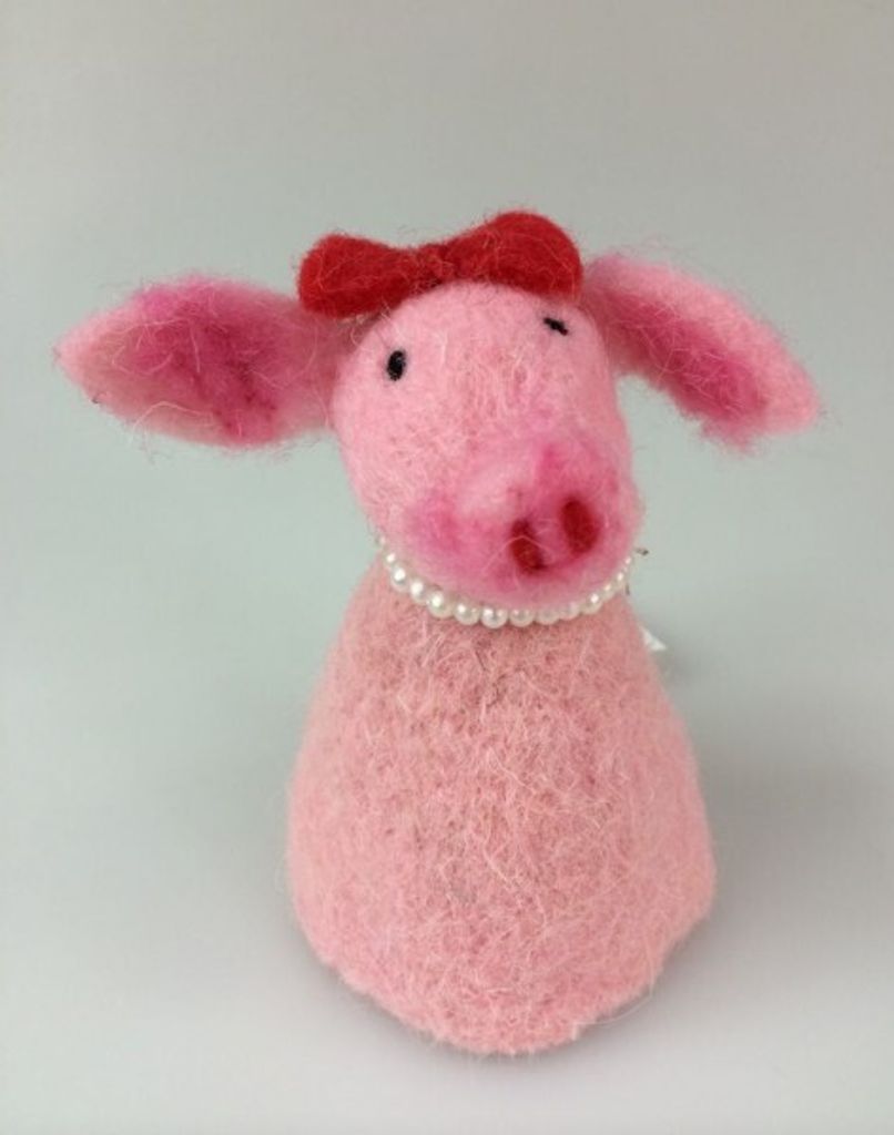 A felted pig figurine with a red bow and pearl necklace.