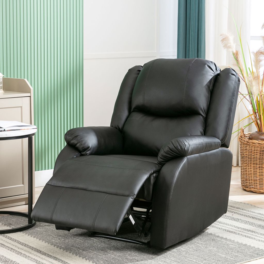 A black leather recliner chair is shown in a room with a light green wall and a woven basket with dried plants.