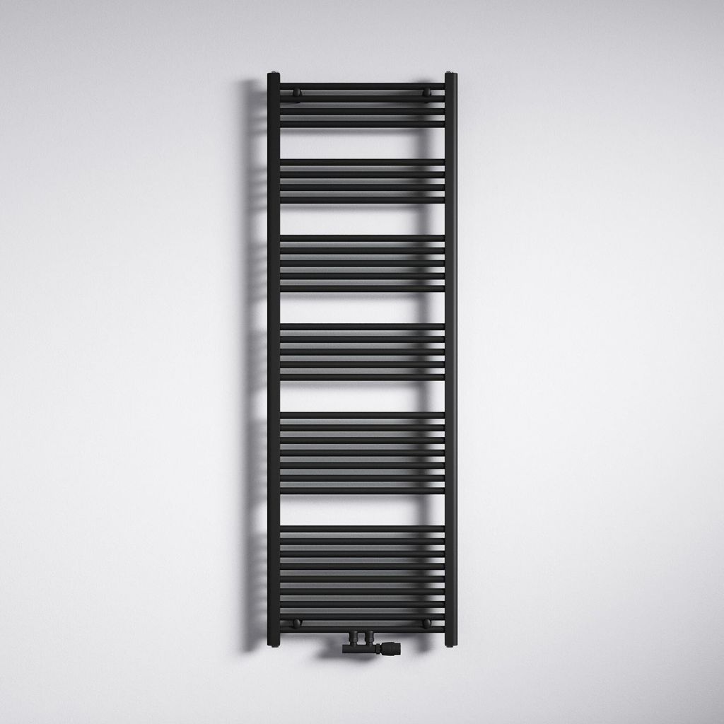 A black radiator is mounted on a white wall.