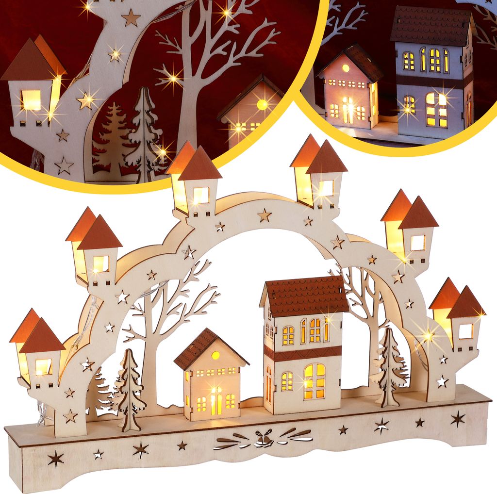 A wooden Christmas arch with illuminated houses and trees, decorated with stars and lights.