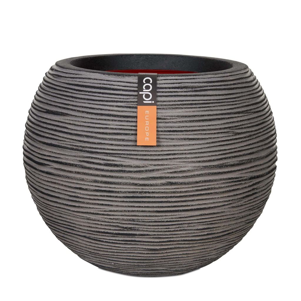 A round, textured planter pot with a label attached.