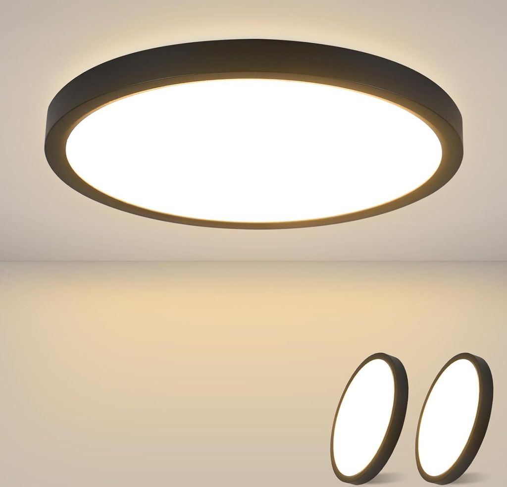 A close-up shot of a modern LED ceiling light fixture with a dark frame and a bright white diffuser, mounted on a white ceiling. Two smaller, similar lights are visible in the lower right corner.