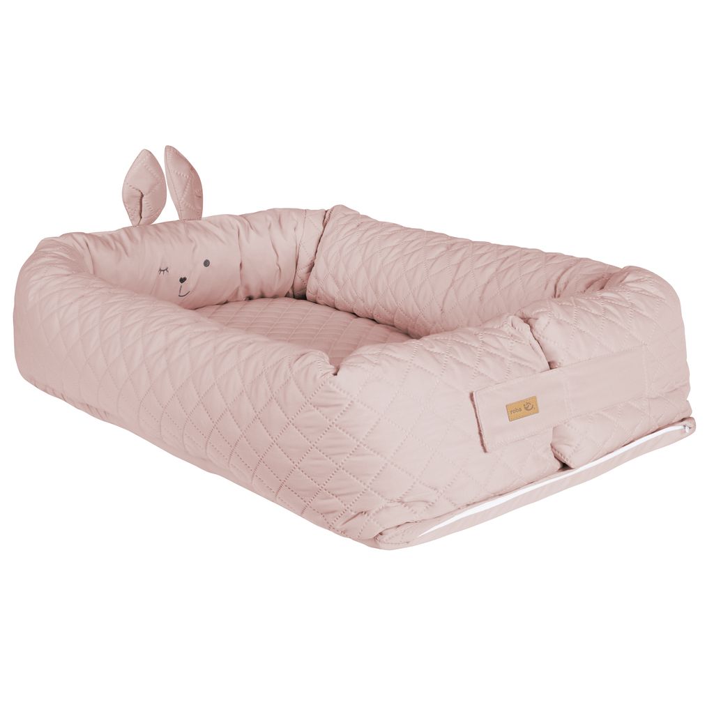 A pink baby lounger with a bunny face and ears.