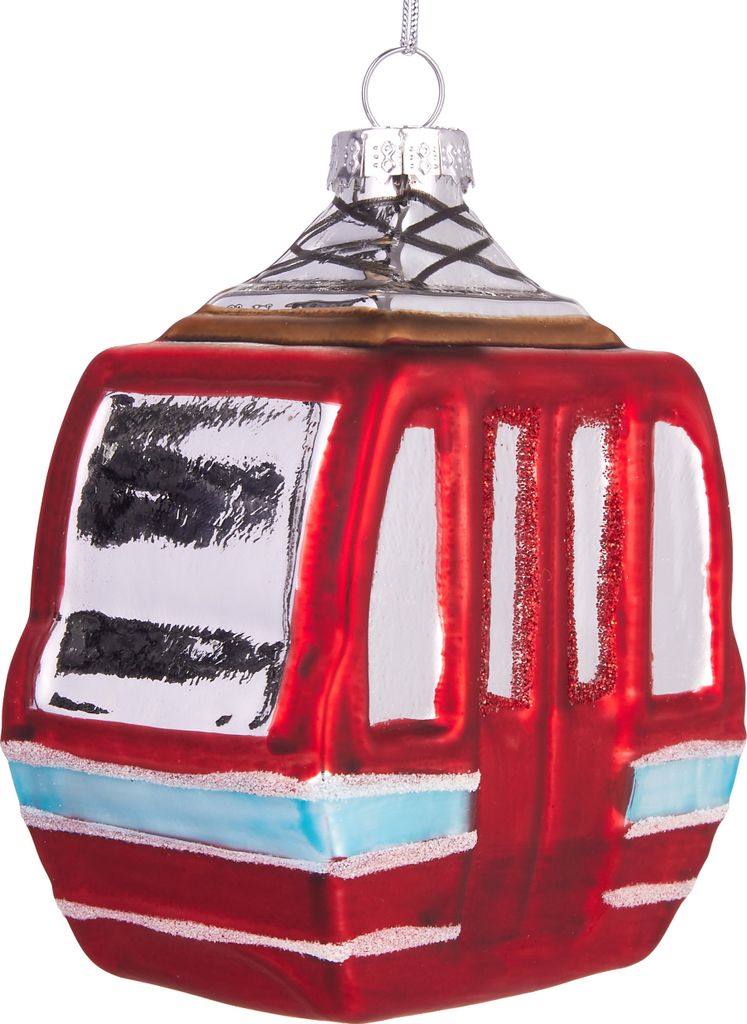 A close-up studio shot of a red glass Christmas ornament shaped like a ski gondola.