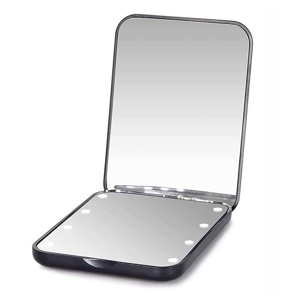 A black compact mirror with lights is open, showing its reflective surface and the lights around the edge.