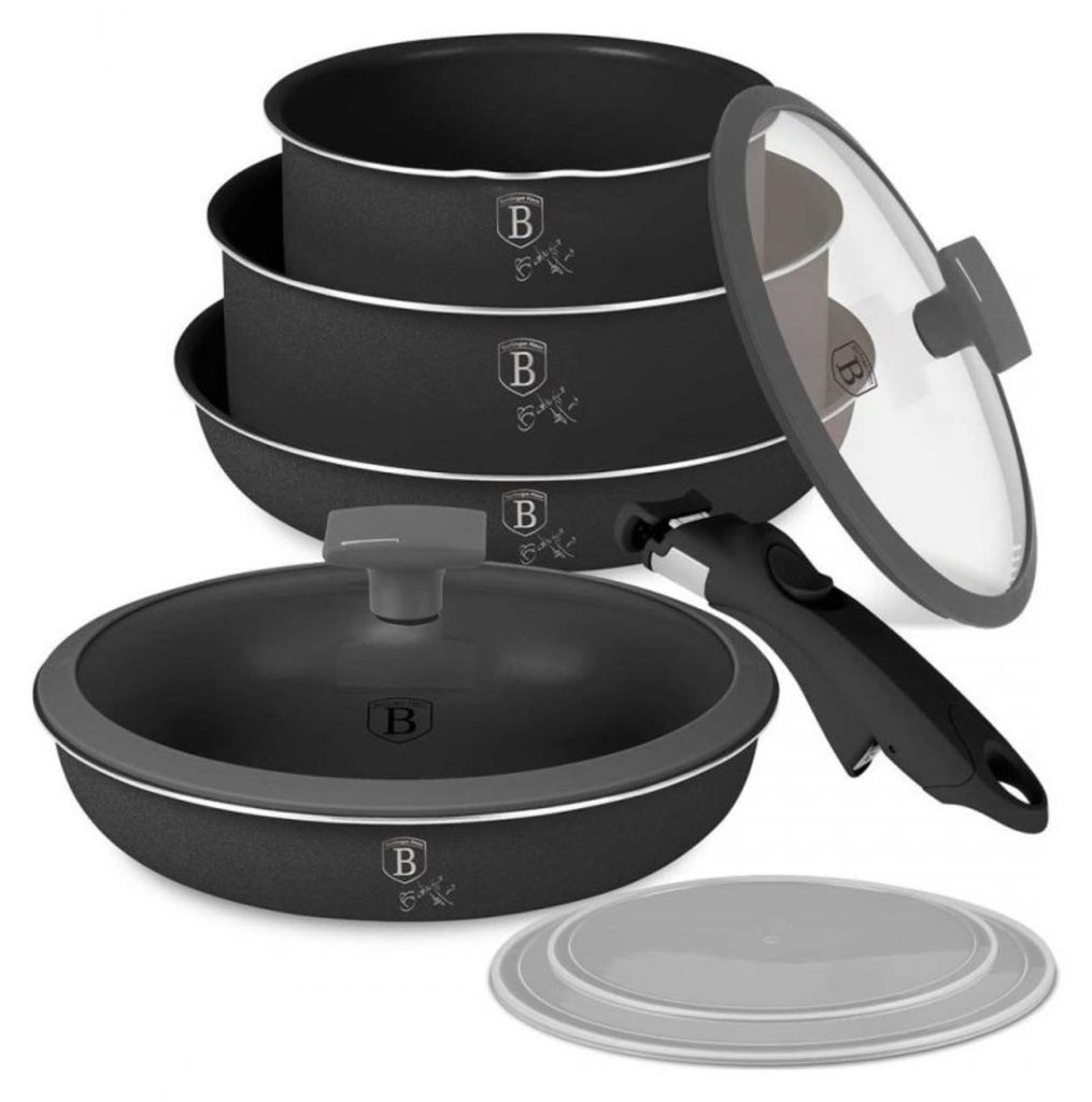 A set of cookware, including pots and a pan, stacked and arranged with a lid and a handle.