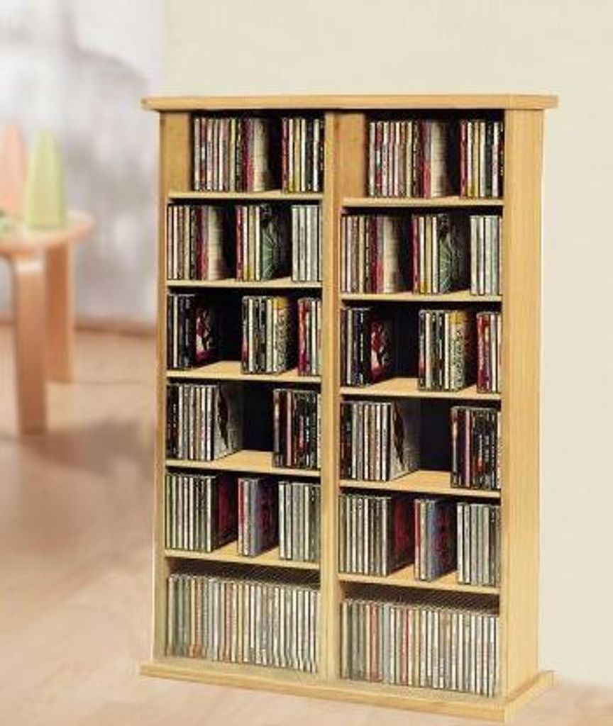A wooden CD/DVD storage shelf filled with CDs and DVDs.