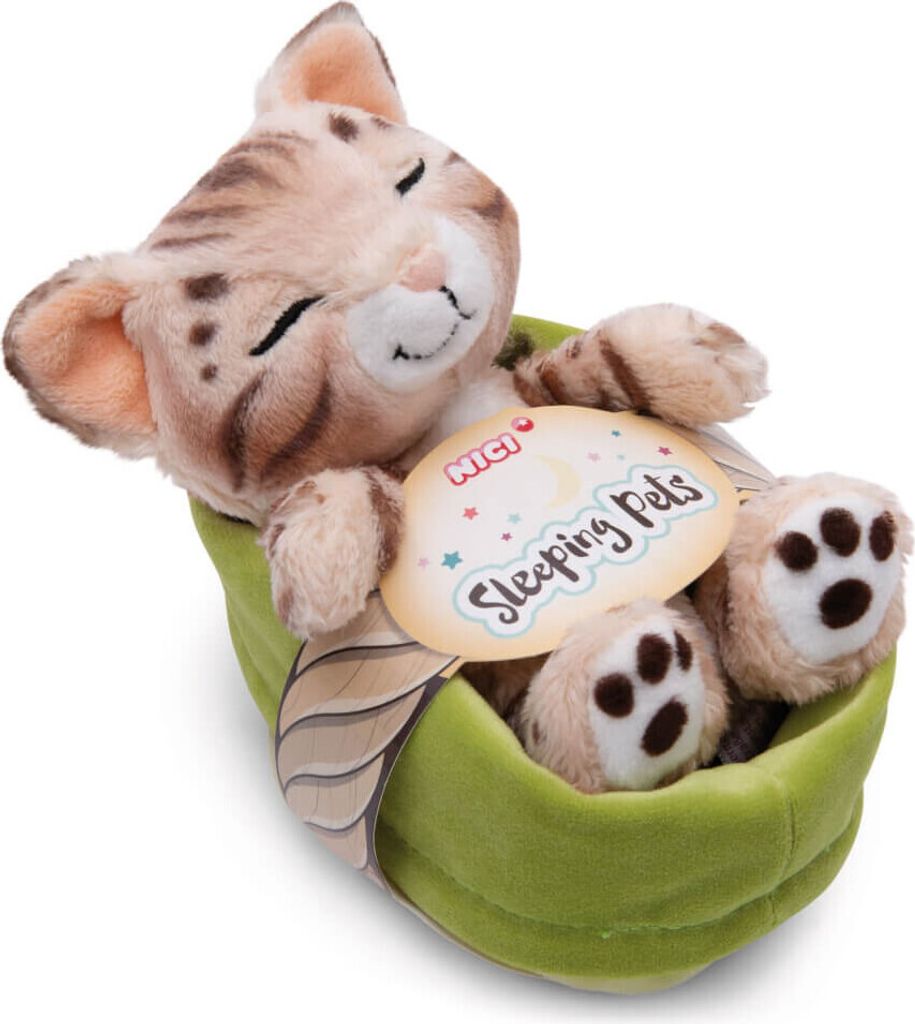 A plush toy cat sleeping in a green pod.