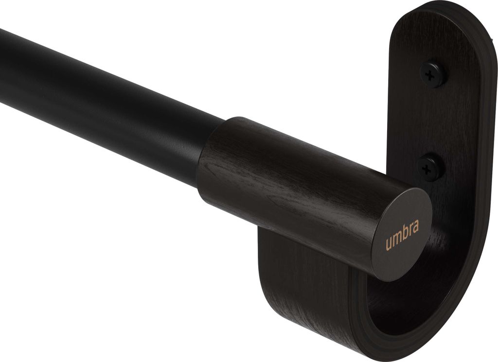 A close-up view of a black metal curtain rod with a dark wood bracket and end cap, featuring the Umbra logo.