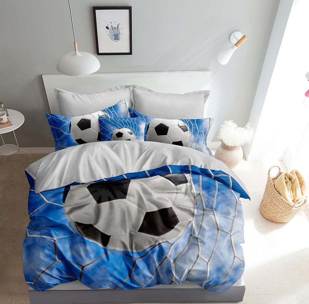 A bedroom scene with a bed made up with soccer-themed bedding.