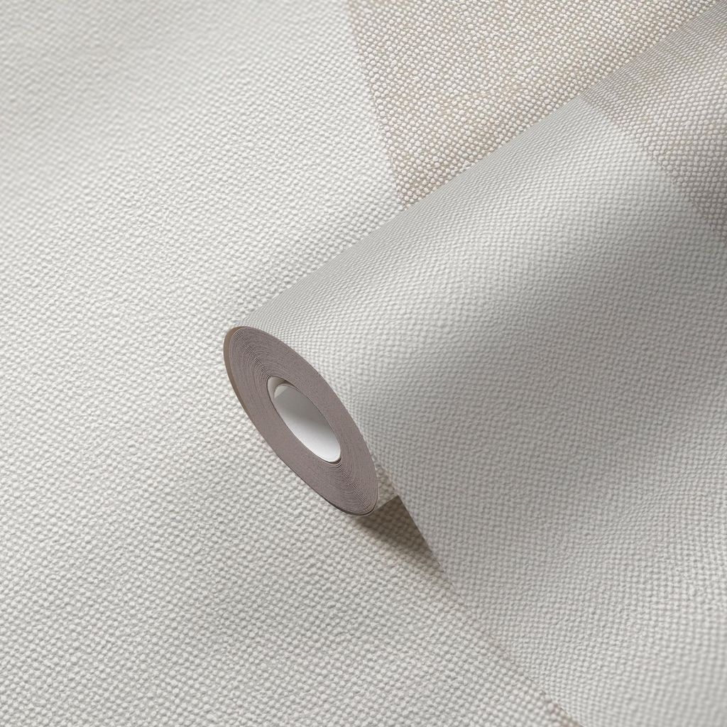 A roll of wallpaper is shown in close-up, with a textured surface and a subtle geometric pattern.