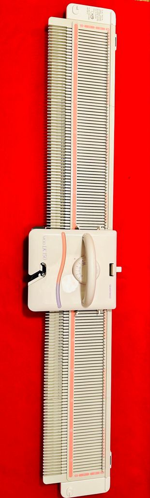 A knitting machine is shown against a red background.