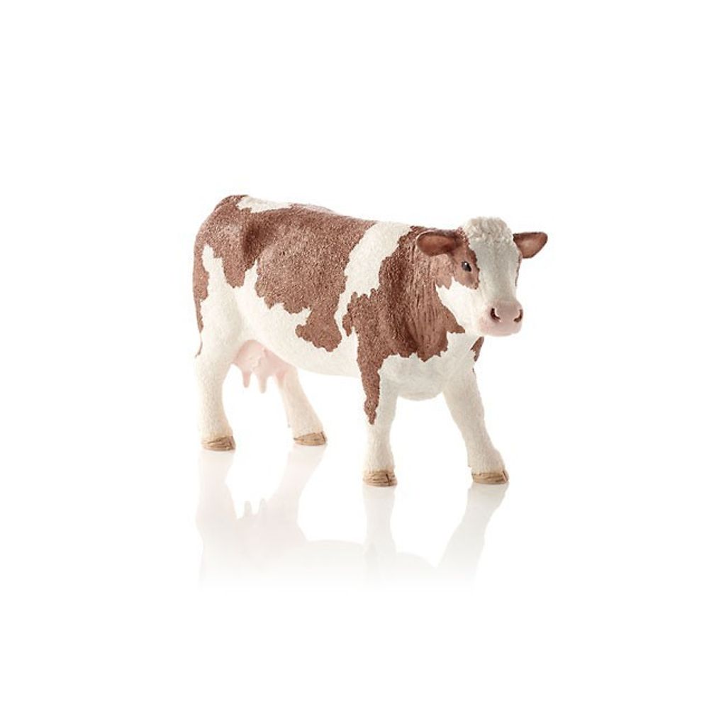 A toy cow figurine on a white background.