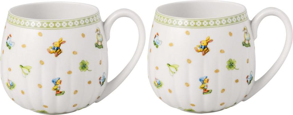 Two white ceramic mugs with a decorative pattern of bunnies and clovers.