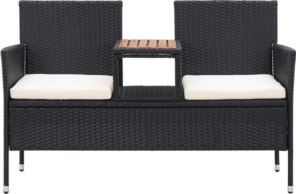 A black rattan garden bench with white cushions and a small wooden table in the center.