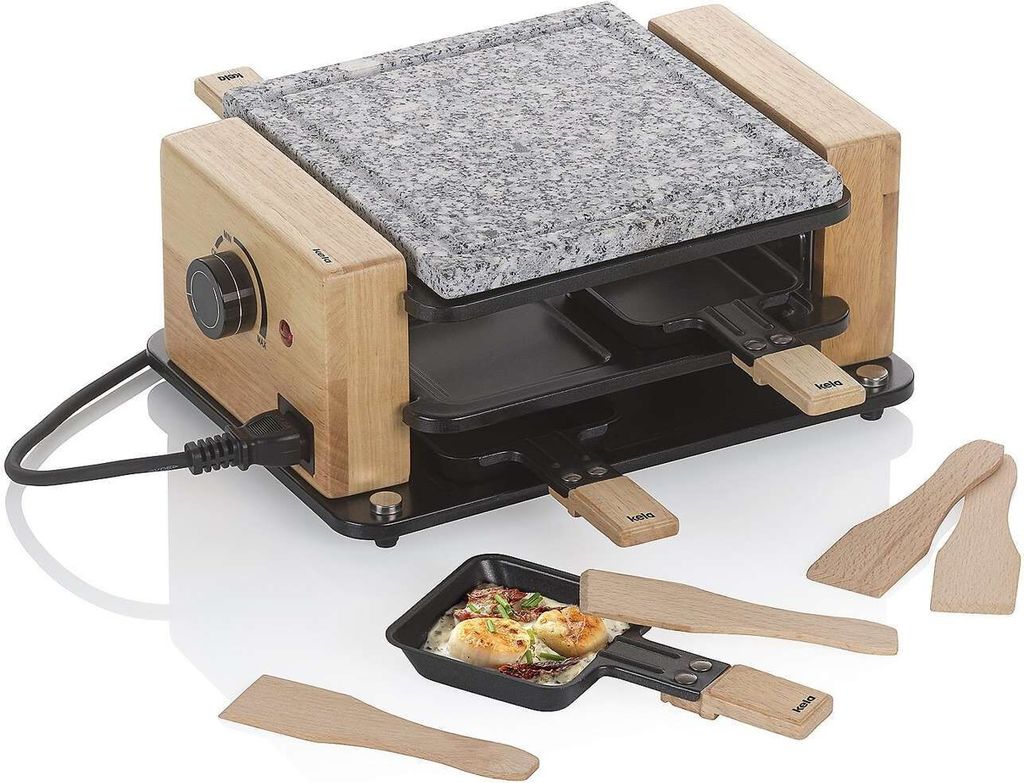 A raclette grill with a stone top and wooden accents, shown with small pans and spatulas.