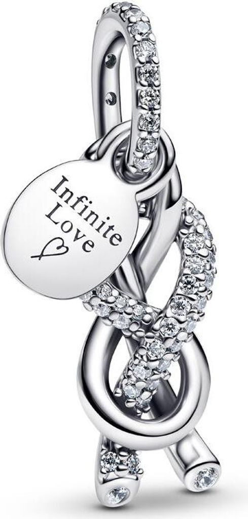 A close-up studio shot of a silver charm with cubic zirconia stones and an engraved oval tag.