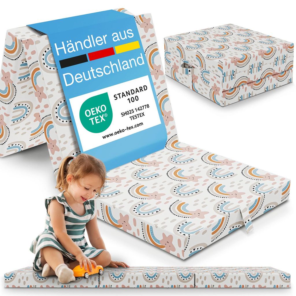 A child playing with a folded mattress that has a rainbow pattern. The mattress is shown in a folded state and unfolded.